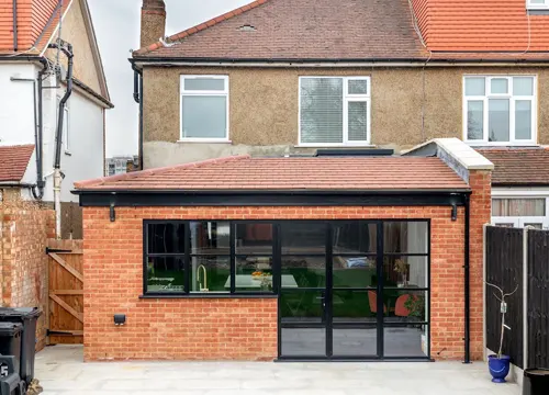 A spacious home extension with large windows and modern finishes, expertly constructed by JH Midland Builder.