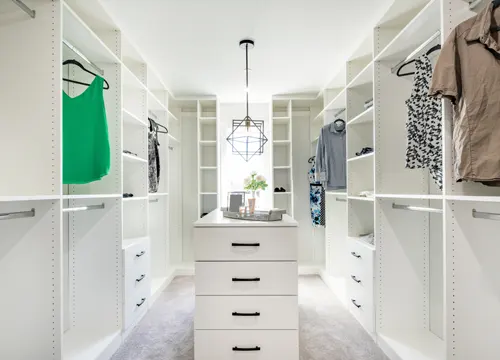 Installation of a custom wardrobe, demonstrating the precision and care taken by JH Midland Builder.