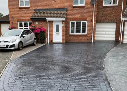 Imprinted driveway in progress, demonstrating the installation process by JH Midland Builder.