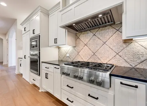 A stunning kitchen remodel featuring high-end finishes and state-of-the-art appliances by JH Midland Builder.