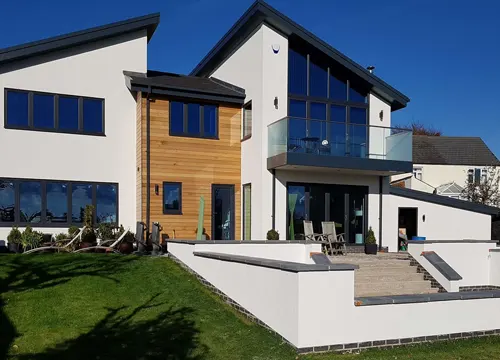 Application of silicon render on a building exterior, enhancing durability and aesthetic appeal.
